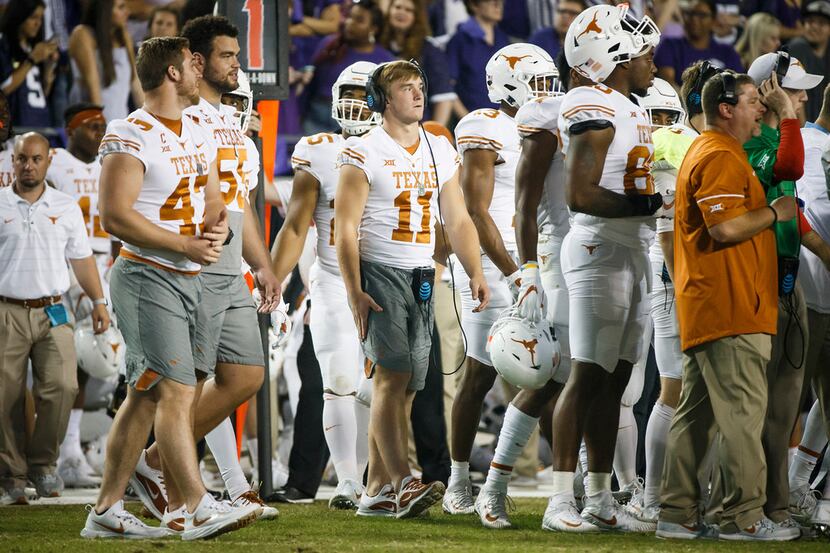 Texas quarterback Sam Ehlinger (11), who did not dress for the game, walks on the sidelines...