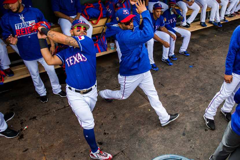 Texas Rangers second baseman Rougned Odor (12) and shortstop Elvis Andrus (1) perform a...