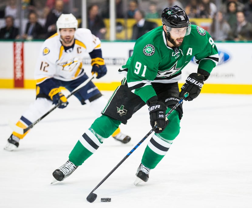 Dallas Stars center Tyler Seguin (91) takes the puck down the ice ahead of Nashville...
