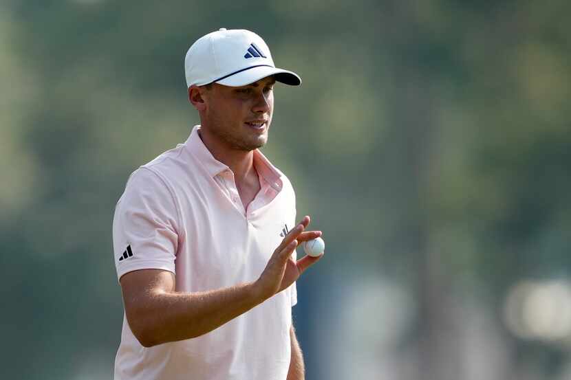 Ludvig Aberg, of Sweden, waves after making a putt on the 12th hole during the second round...