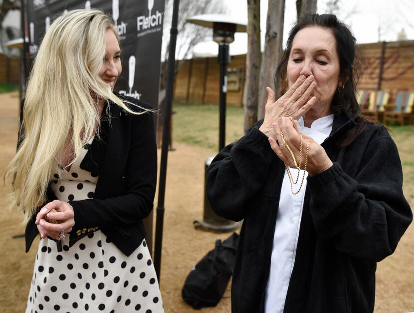 Vickie Fletcher, right, CEO and co-owner of Fletch, kisses a Fletcher family heirloom...