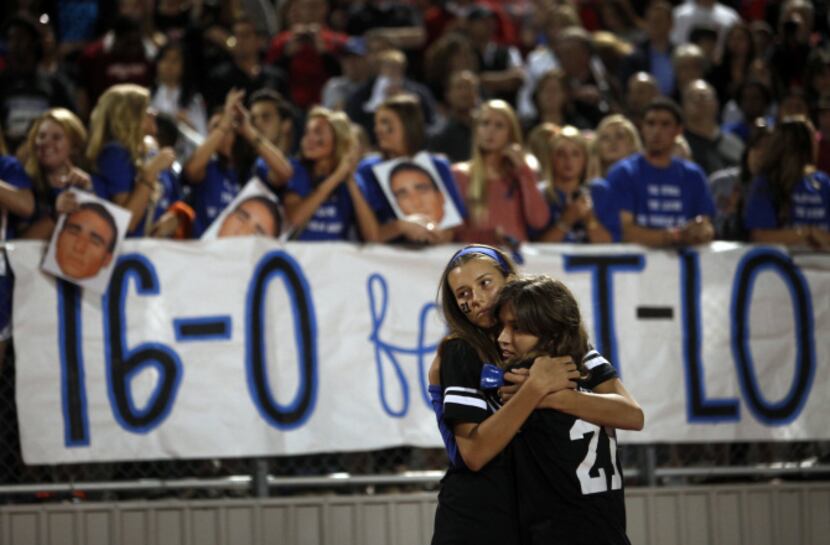 Coppell High School students Courtney Echerd and Tiffany Breitenwischer embraced following a...