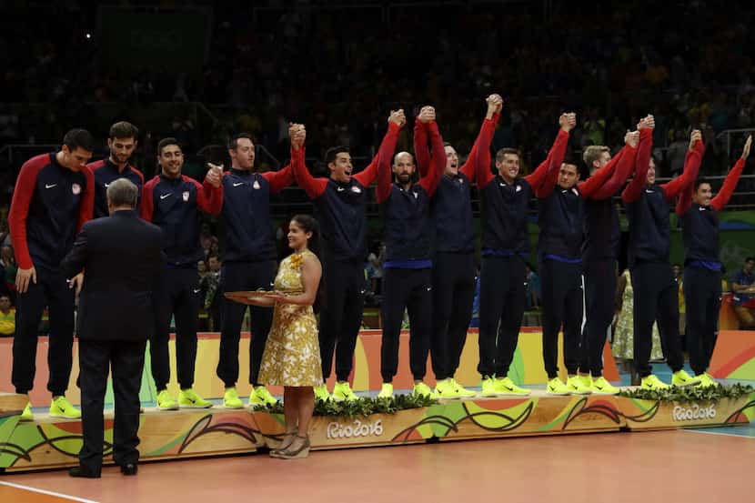 Members of the United States' team received their bronze medals during an awarding ceremony...