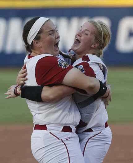 Oklahoma catcher Lea Wodach (right) celebrates with pitcher Paige Parker (left) after...