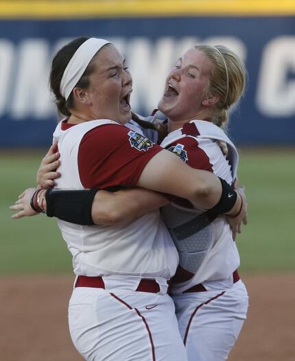 Oklahoma catcher Lea Wodach (right) celebrates with pitcher Paige Parker (left) after...