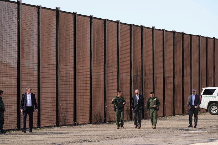 President Joe Biden walks with U.S. Border Patrol agents along a stretch of the U.S.-Mexico...