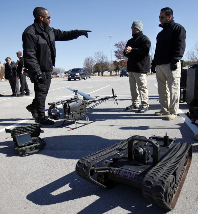 Arlington police officer Jesse Manning, left, shows off the department's new robotic...