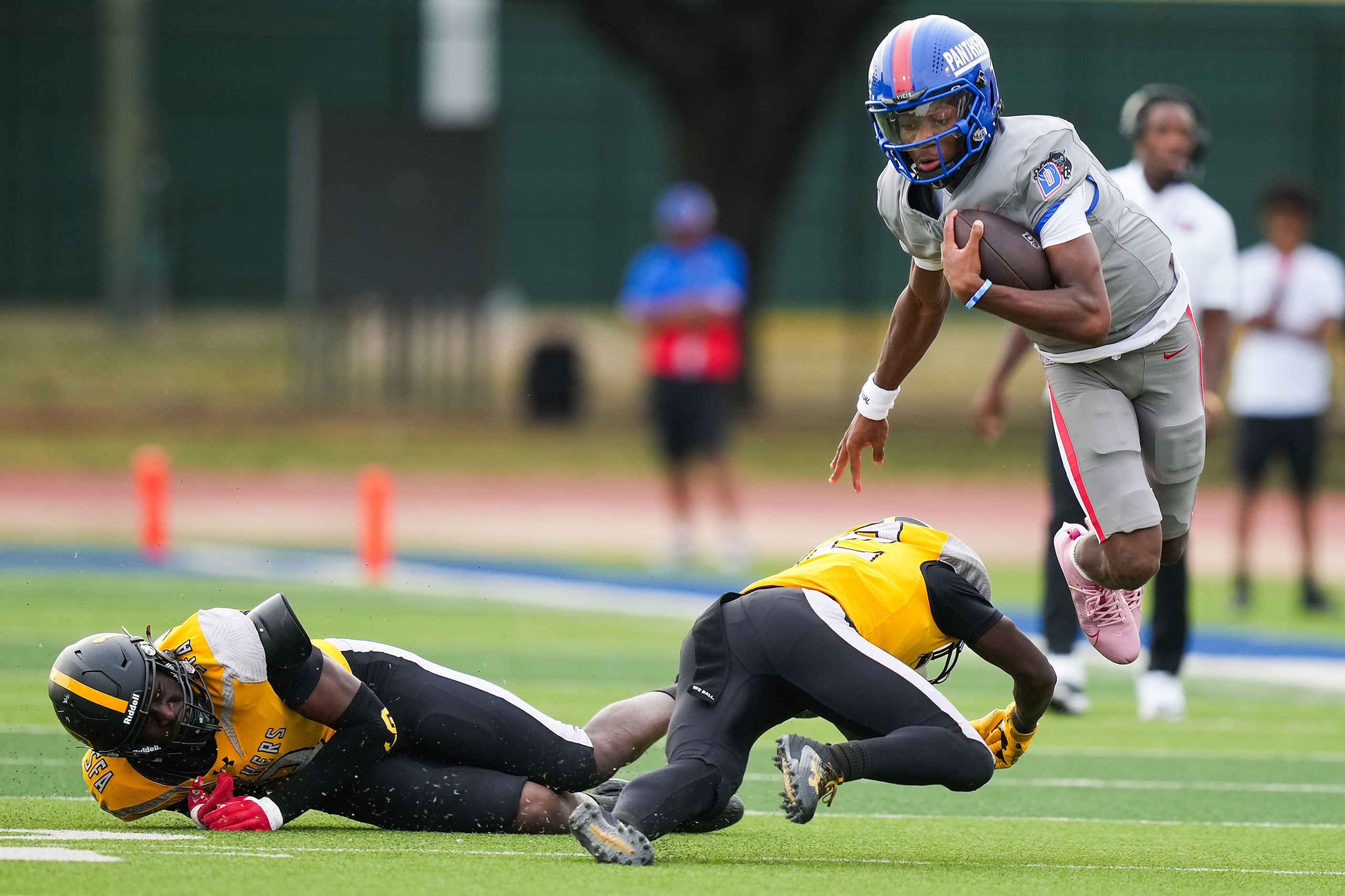 Duncanville quarterback Keelon Russell gets past St. Frances Academy defensive back Wayne...