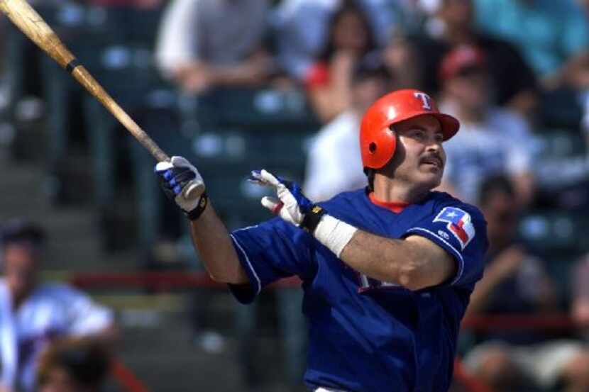 Texas Rangers' Rafael Palmeiro  hits a solo home run during the 8th inning against the...