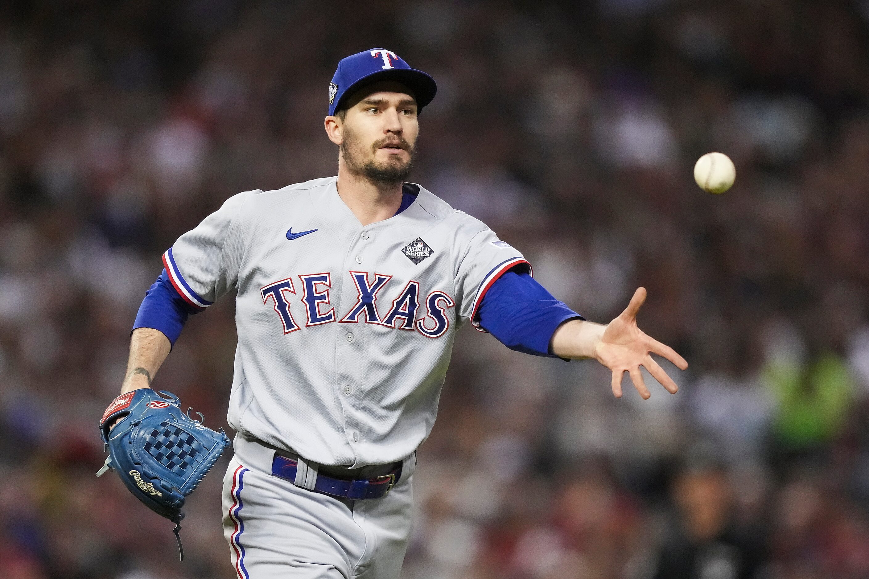 Texas Rangers pitcher Andrew Heaney tosses to first to get Arizona Diamondbacks right...