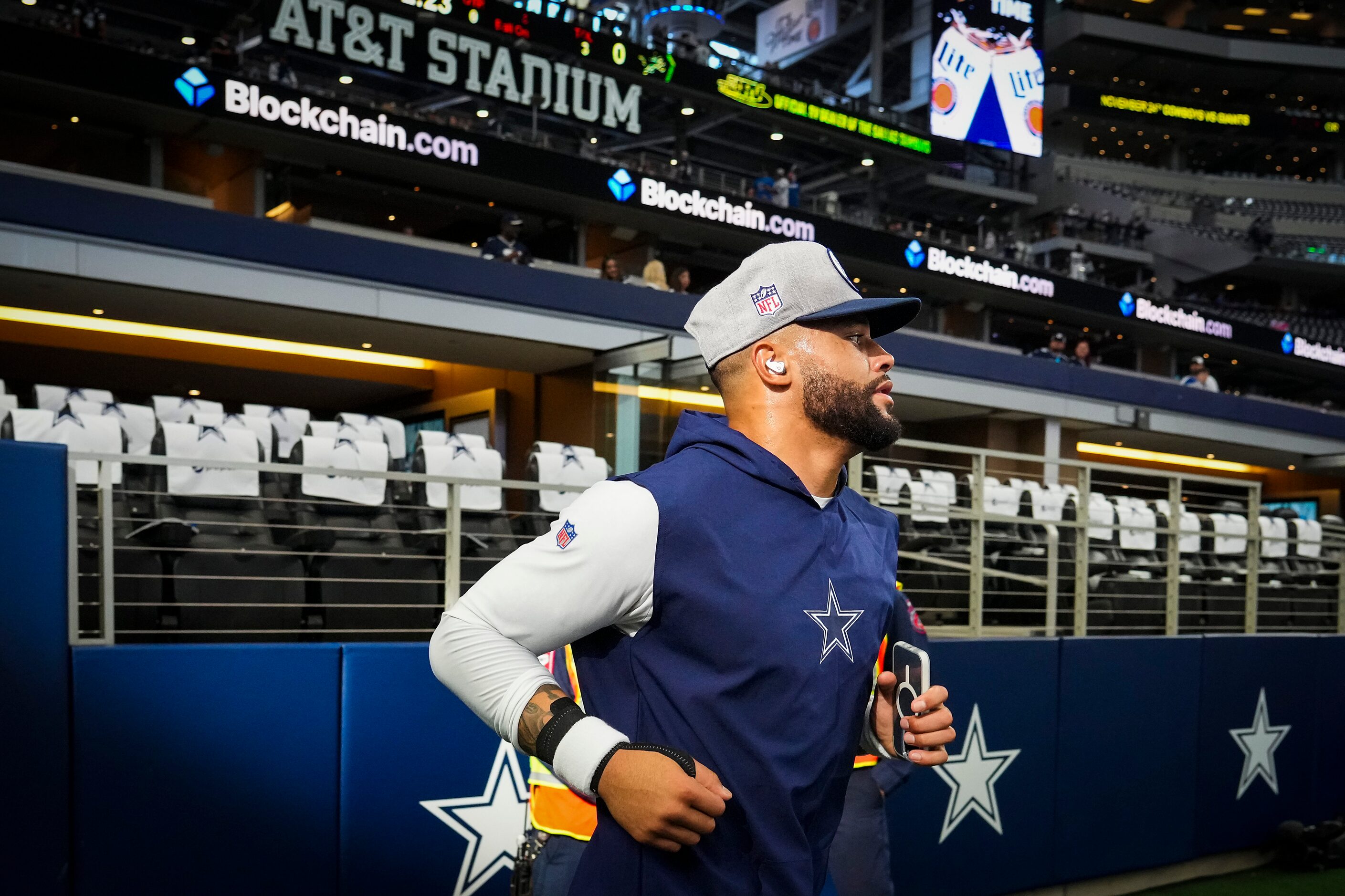 Dallas Cowboys quarterback Dak Prescott takes the field to warm up before an NFL football...