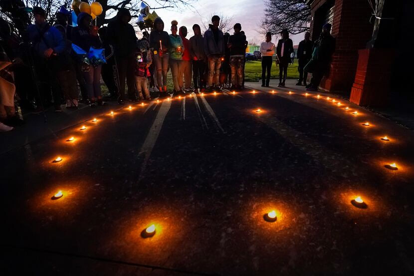 Mourners gather for a vigil for Marc "Flea" Strickland, the 18-year-old victim of a shooting...