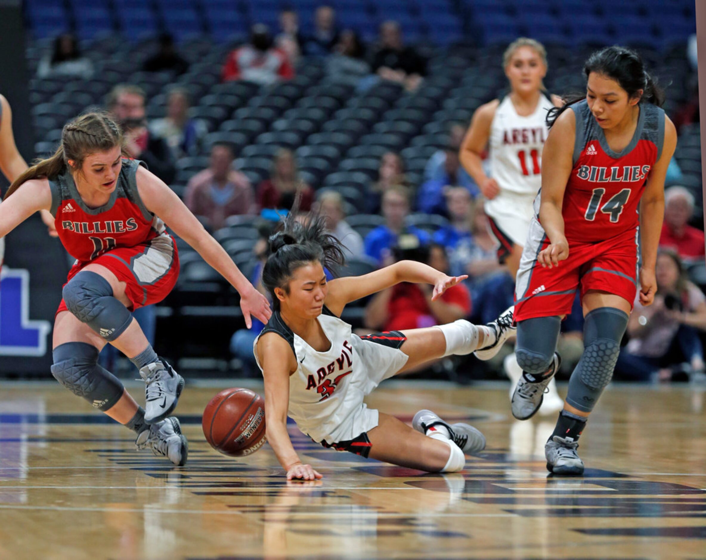 Argyle guard Madi Lumsden #32 is trapped by Fredericksburg guard Brittley Bowers #11 and...