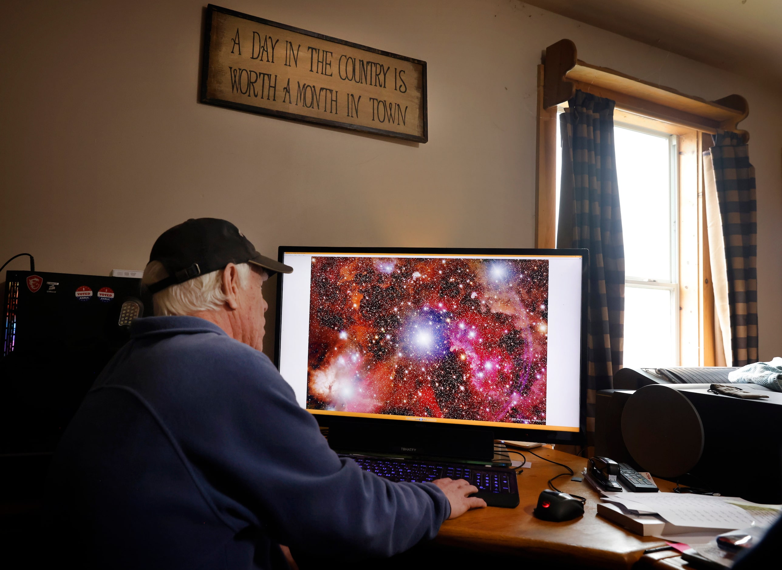 Astrophotographer Peter Armstrong ,78, views past images of stars and galaxies he’s made...