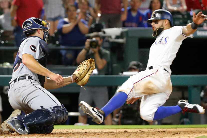 Texas Rangers second baseman Rougned Odor (12) is out at home as Detroit Tigers first...