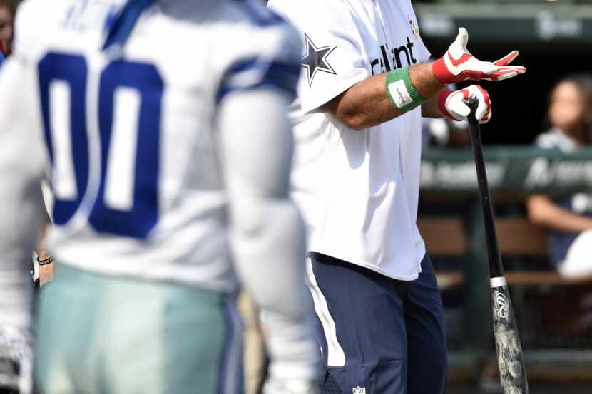 Dallas Cowboys player Travis Frederick, right, prepares to bat during the Dallas Cowboys'...