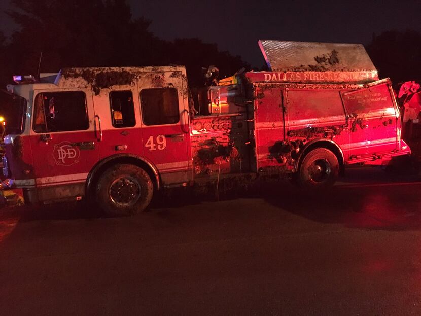 A Dallas firefighter was injured when an engine rolled on its side in central Oak Cliff.