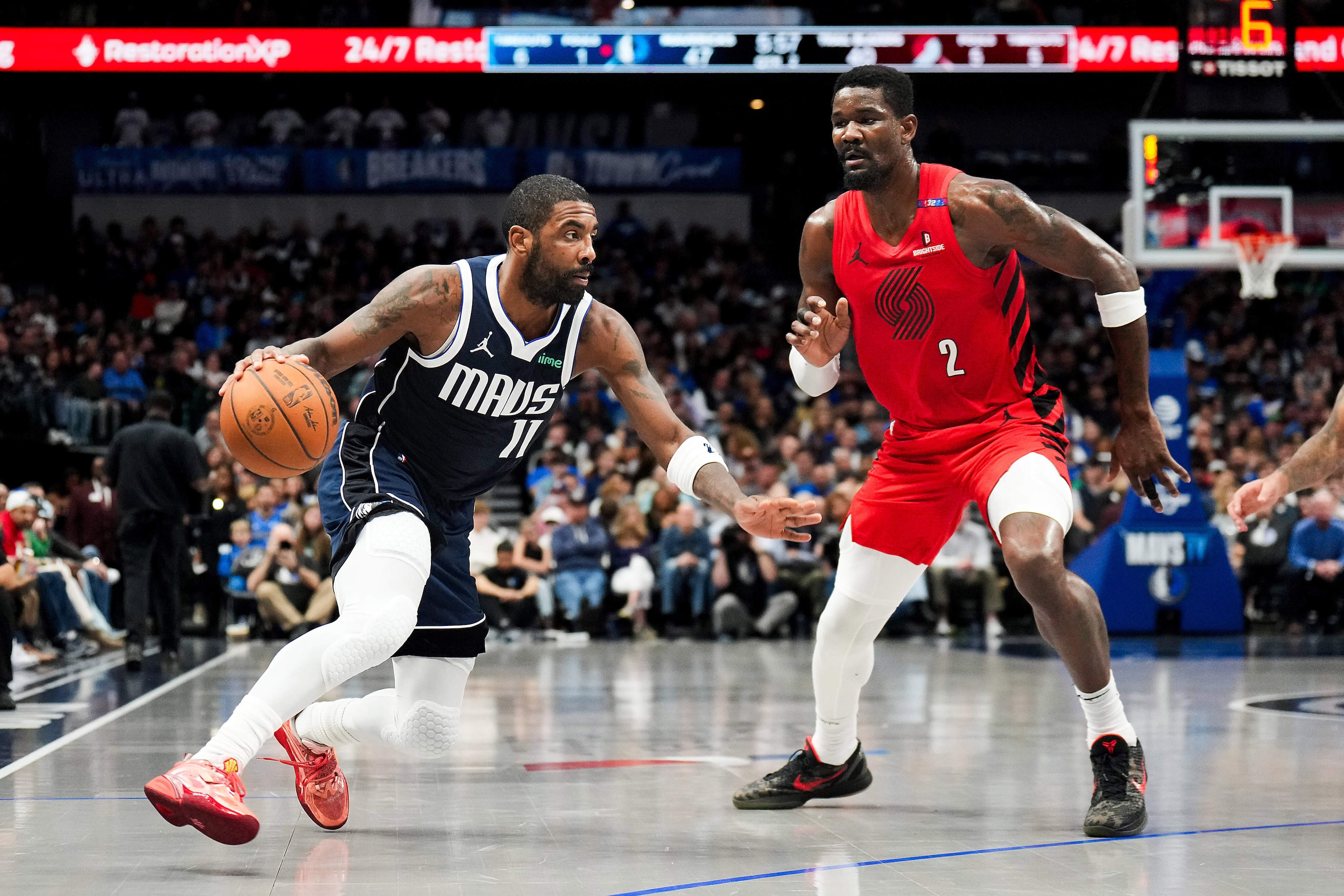 Dallas Mavericks guard Kyrie Irving (11) drives on Portland Trail Blazers center Deandre...