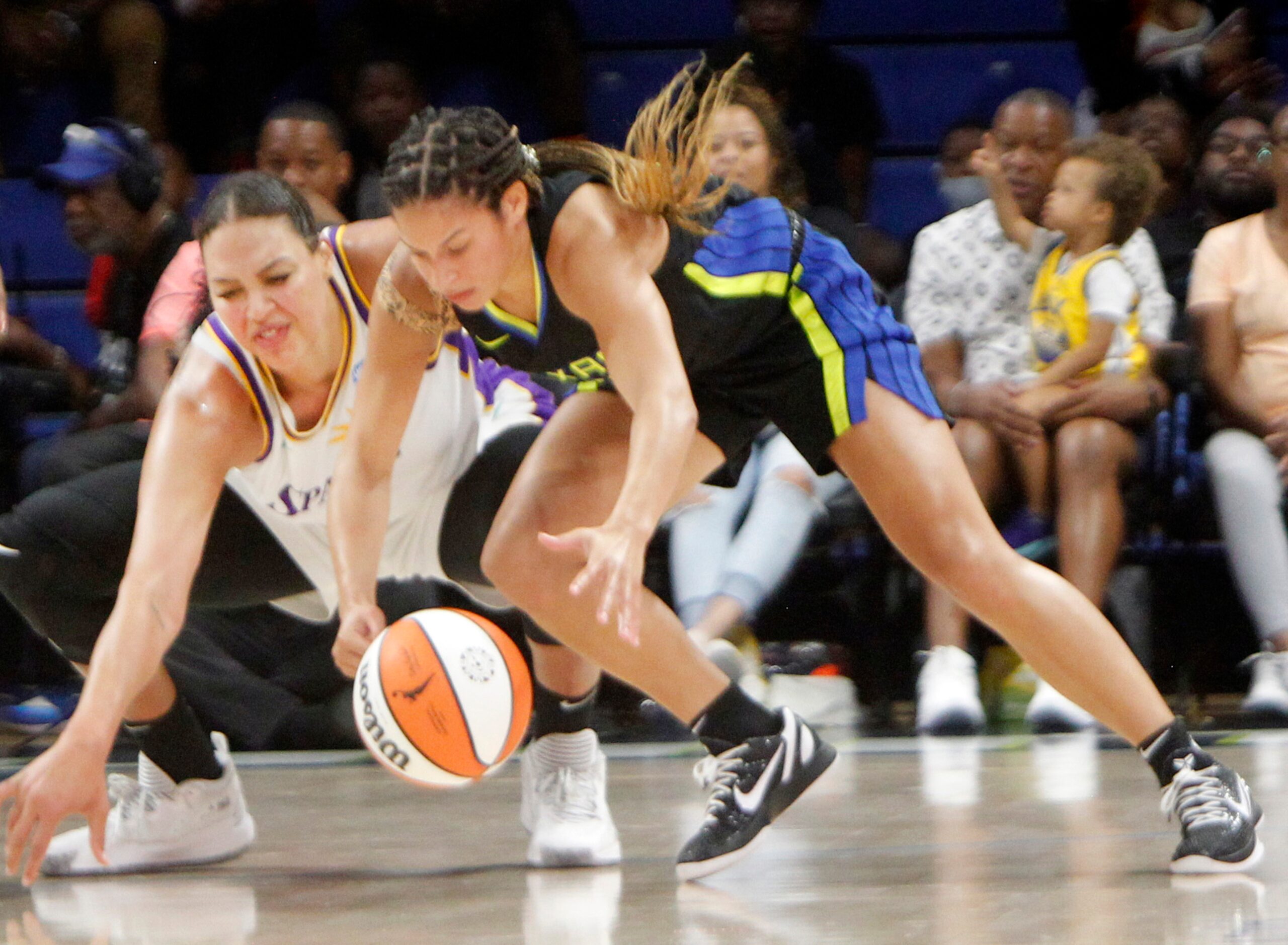 Dallas Wings guard Veronica Burton (12), foreground, beat LA Sparks center Liz Cambage (1)...