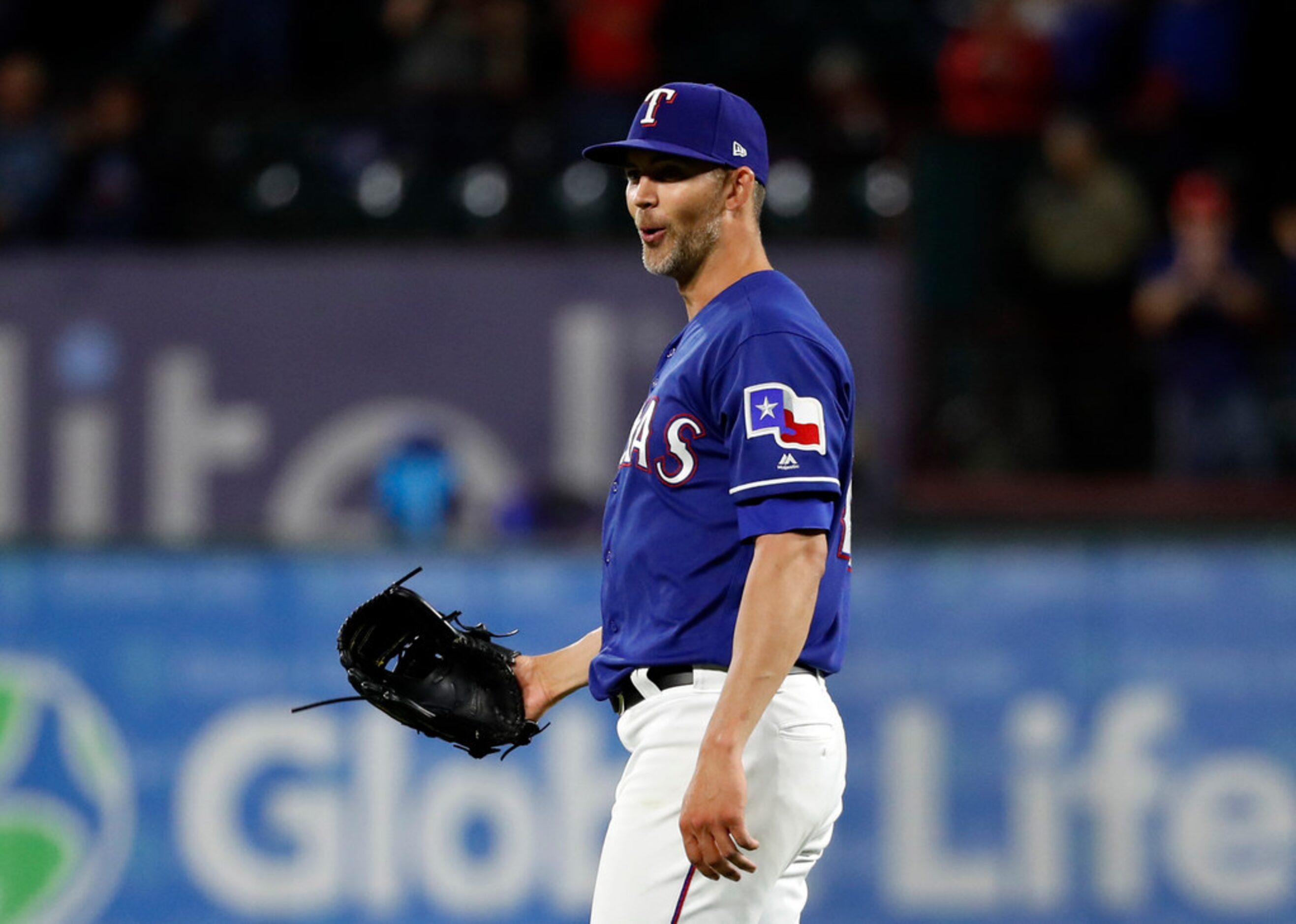 Texas Rangers starting pitcher Mike Minor smiles after the final out against the Los Angeles...