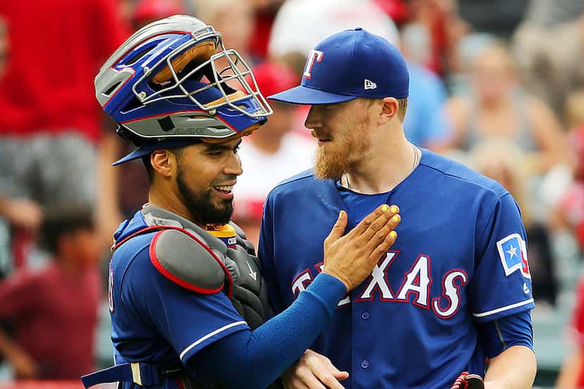 Texas Rangers Robinson Chirinos and pitcher Jake Diekman celebrate their win over the Los...