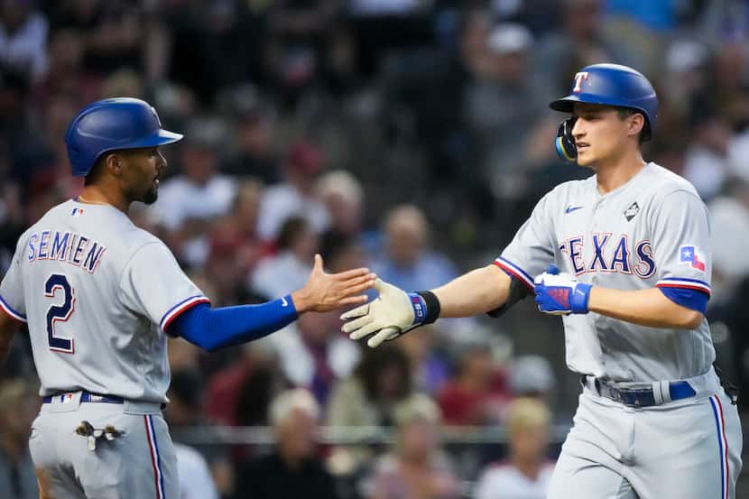 Texas Rangers shortstop Corey Seager celebrates with second baseman Marcus Semien after...