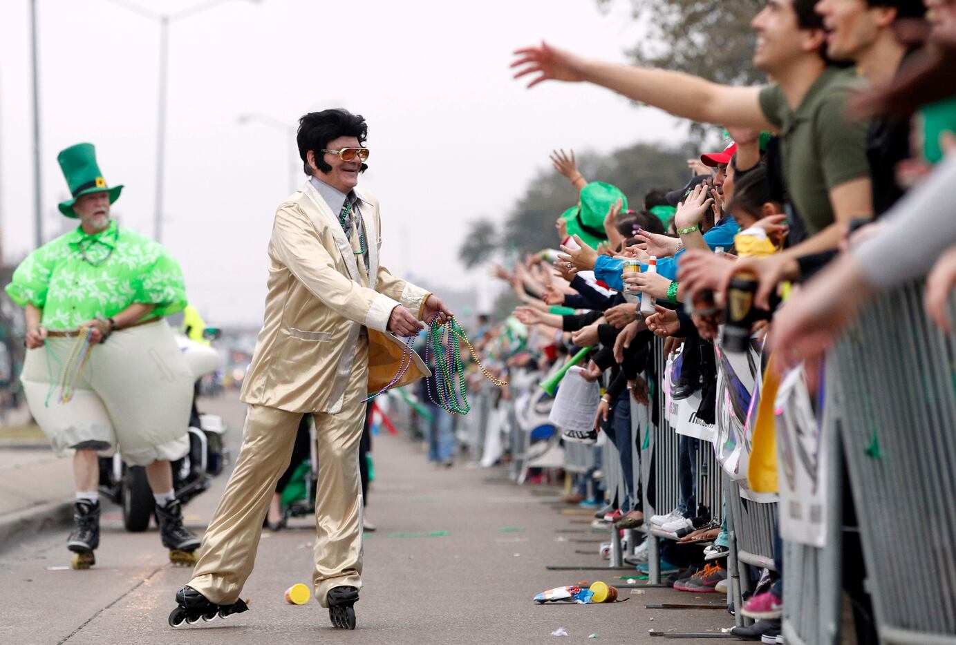 An Elvis impersonator handed out beads  during the Dallas St. Patrick's Parade & Festival.