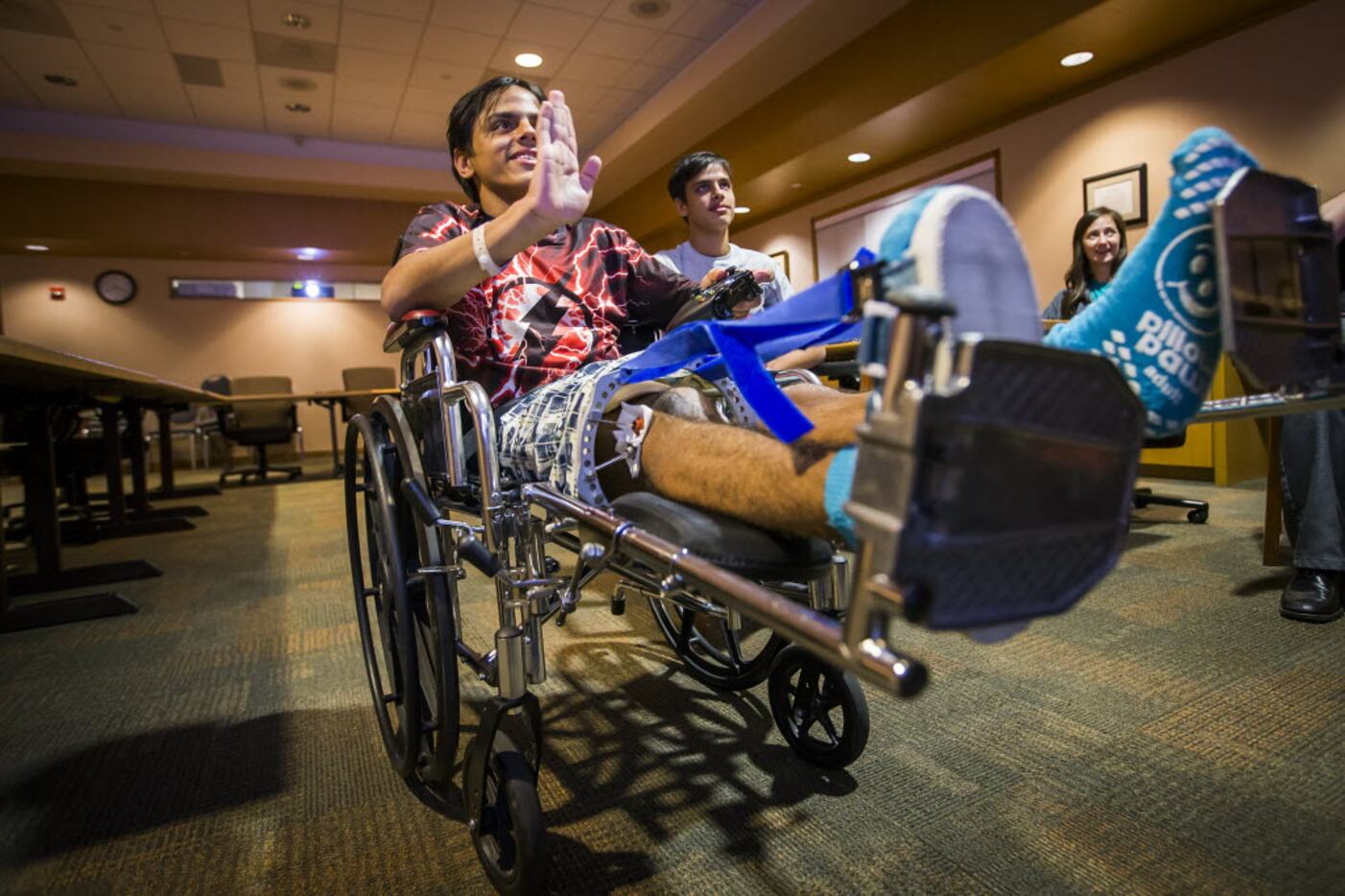 Alim Zubtsov uses a remote control at Texas Scottish Rite Hospital for Children to move a...
