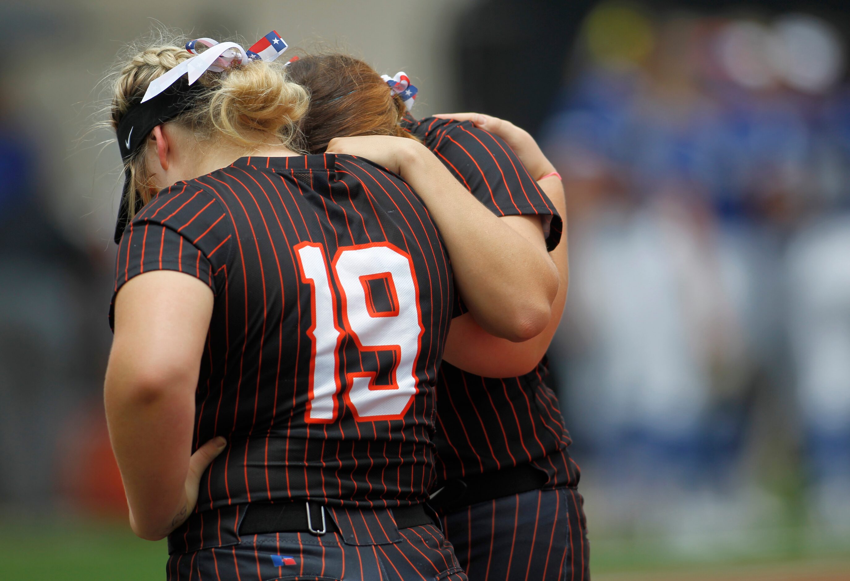 Aledo teammates Texas Ray (19) pauses to pray with a teammate at first base prior to the...