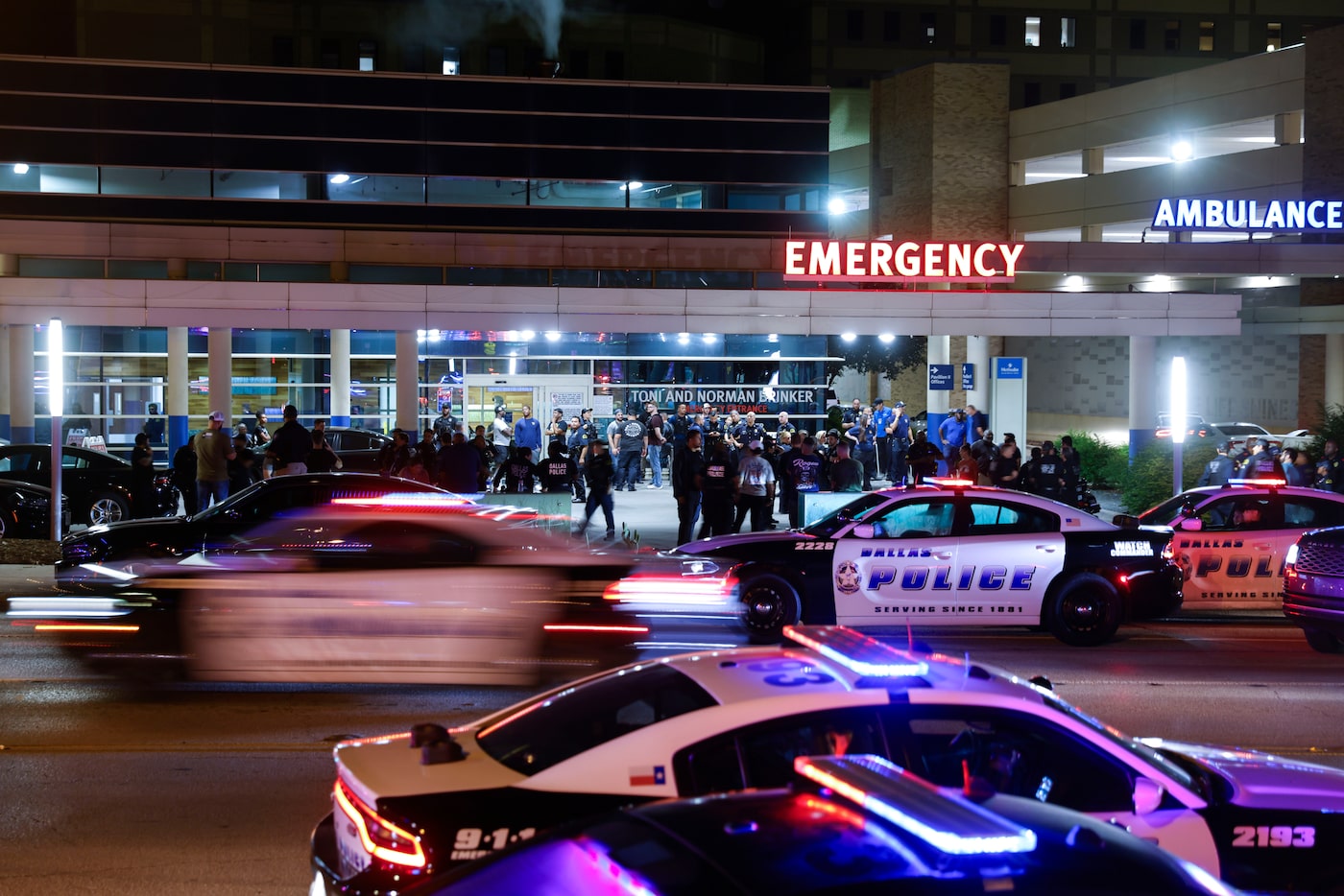 Dallas Police Department officers gather, on Friday, Aug. 30, 2024, outside of the ER at...