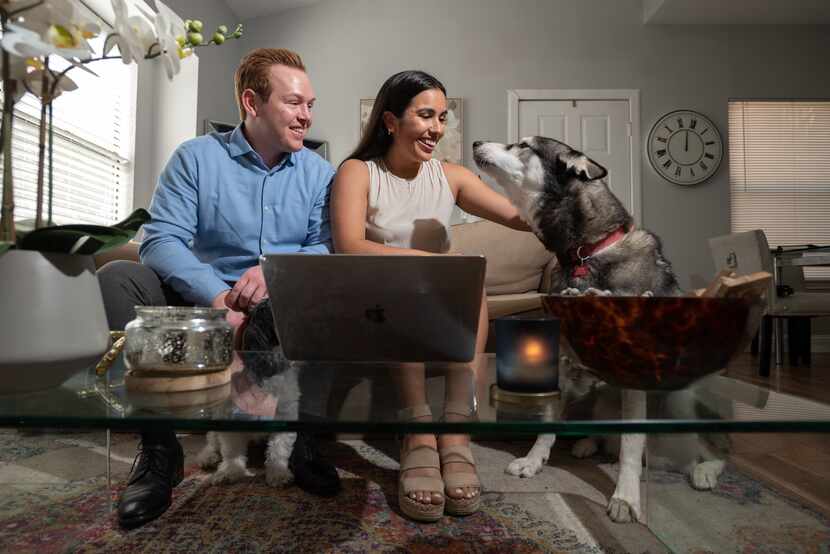 Jake Crews, 27, his fiancee Jacqueline Pytel, 26, and their dog, Duke, sit behind a laptop...