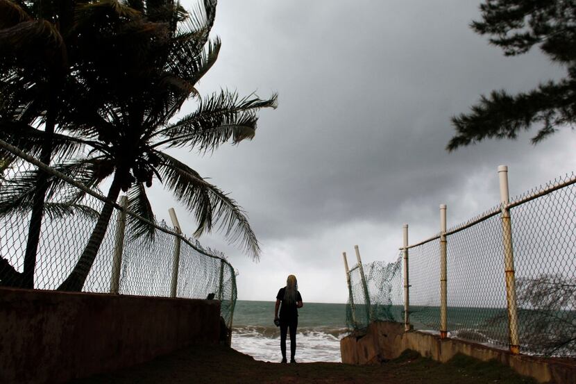TOPSHOT - A woman looks at heavy surf as Hurricane Irma approaches Puerto Rico in Luquillo,...