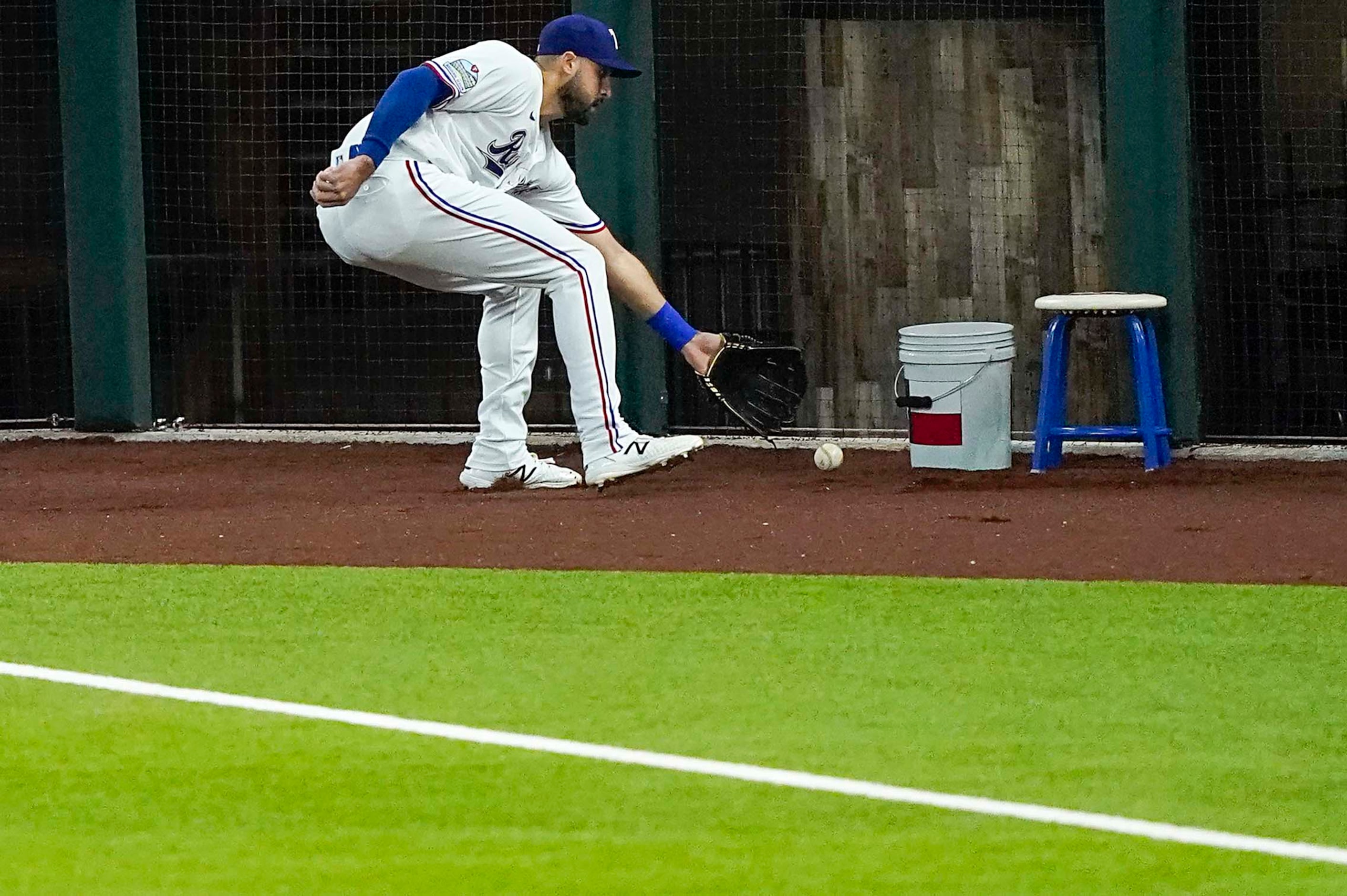 Texas Rangers outfielder Joey Gallo goe into foul territory to grab an RBI single off the...