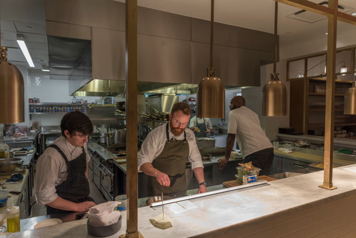Line cook Will Brown, left, and Executive Chef Jeramie Robison work in the kitchen at City...