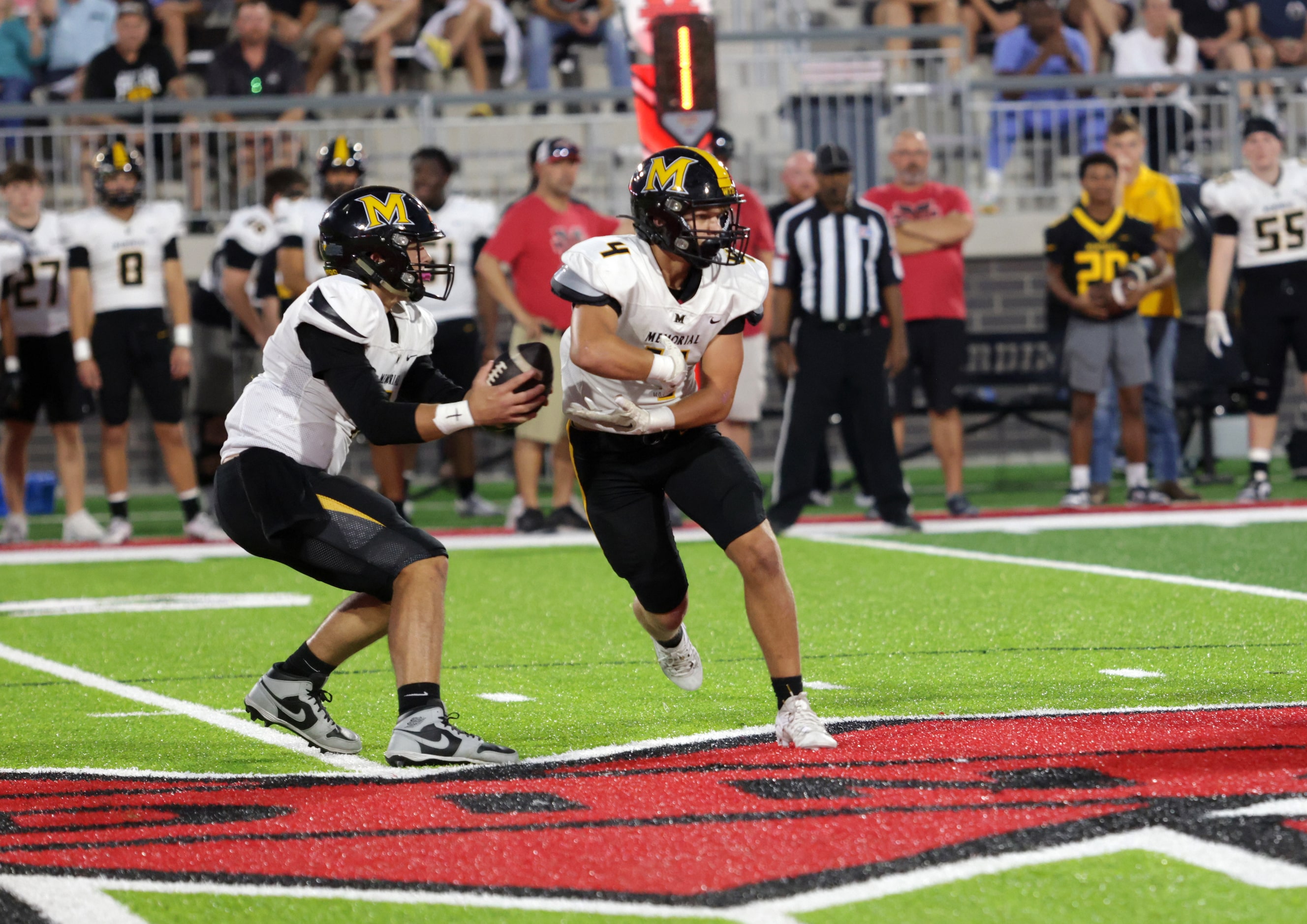 Memorial player #7 Benjamin Wilson fakes a handoff to player #4 Beckett Martin during the...