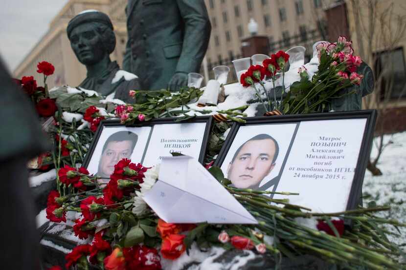 
Photos of Lt. Col. Oleg Peshkov (left) and sailor Alexander Pozynich were placed at a...