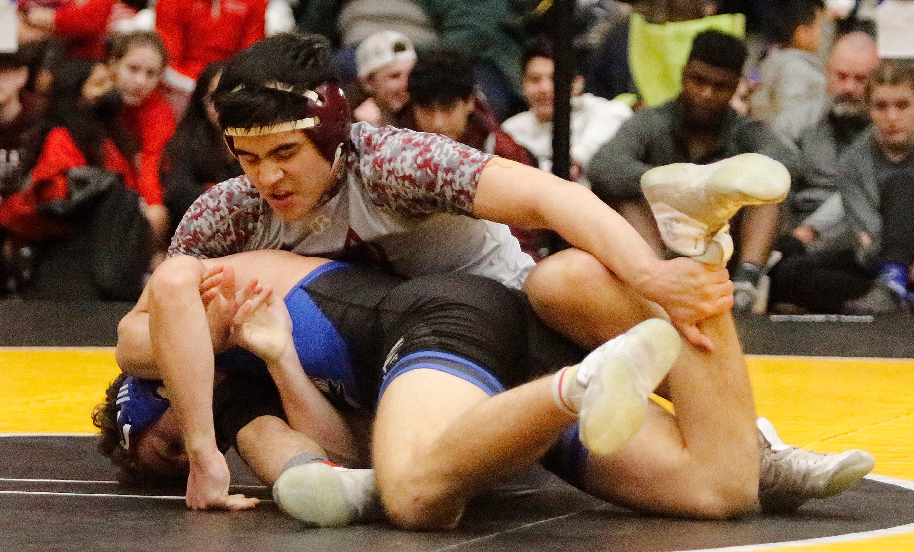 Alex Zavala (top) of Frisco Heritage High School gets a hold of Henry Bumgarner of...