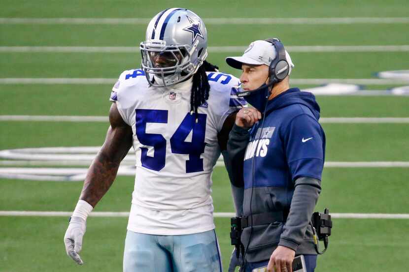 Dallas Cowboys middle linebacker Jaylon Smith (54) checks in with defensive coordinator Mike...