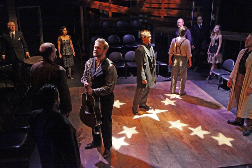 Actor Ian Ferguson (Samuel Arnold), left, stands with other actors during a scene of the...