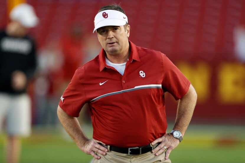 FILE - In this Nov. 3, 2016, file photo, Oklahoma head coach Bob Stoops stands on the field...
