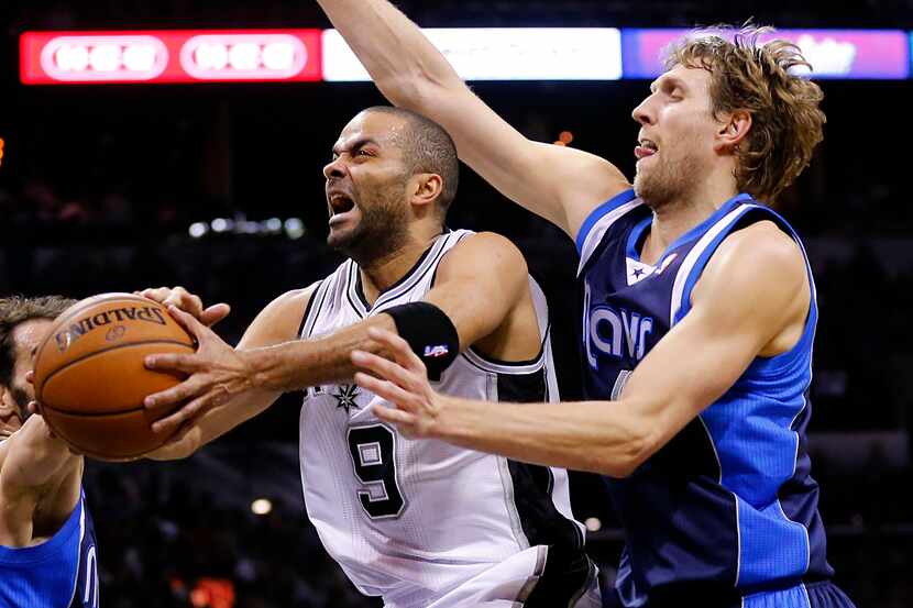 San Antonio Spurs guard Tony Parker (9) splits Dallas Mavericks forward Dirk Nowitzki (41)...