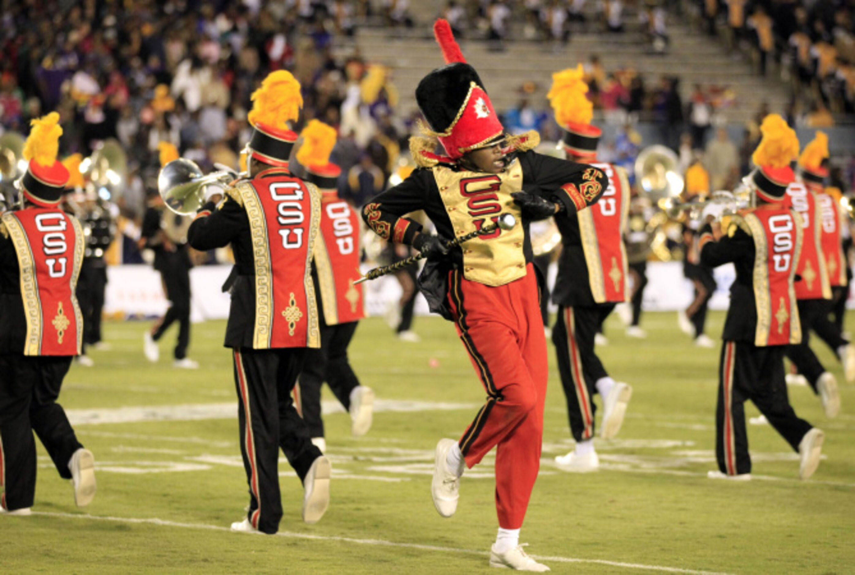 A Grambling drum major dances, as the band marches during the halftime show of a NCAA...