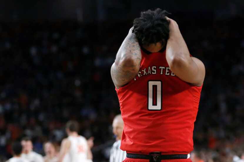 Texas Tech guard Kyler Edwards buries his face in his jersey after the Red Raiders' 85-77...