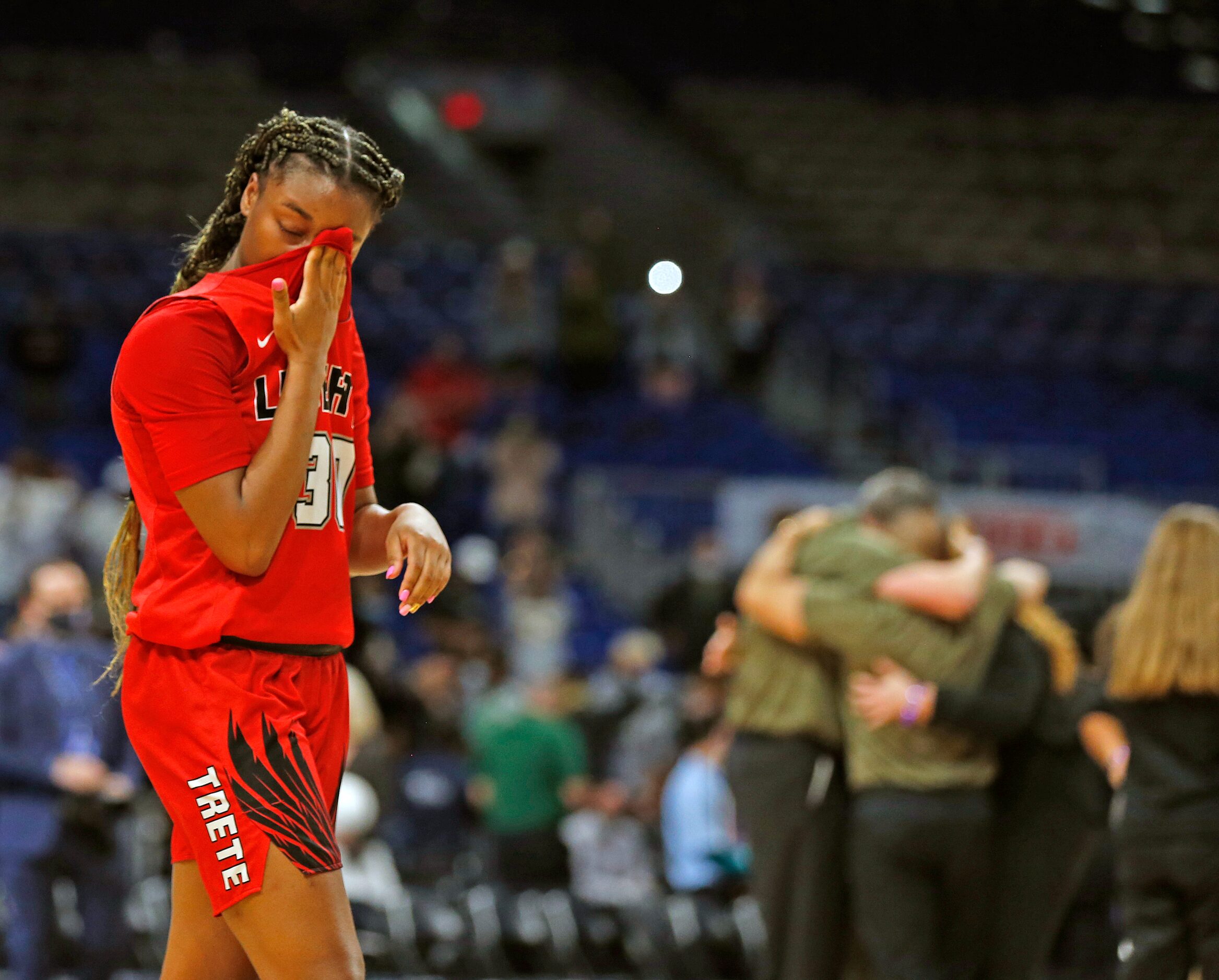 Frisco Liberty Jazzy Owens-Barnett #30 walks on the court as Cedar Park coaches celebrate in...