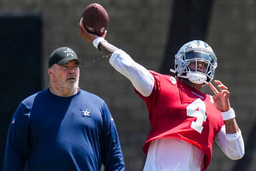 Dallas Cowboys quarterback Dak Prescott (4) throws a pass as head coach Mike McCarthy looks...