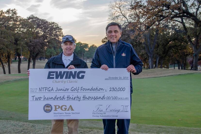 Fin Ewing III (left), owner of The Ewing Automotive Group, presents a check to Northern...