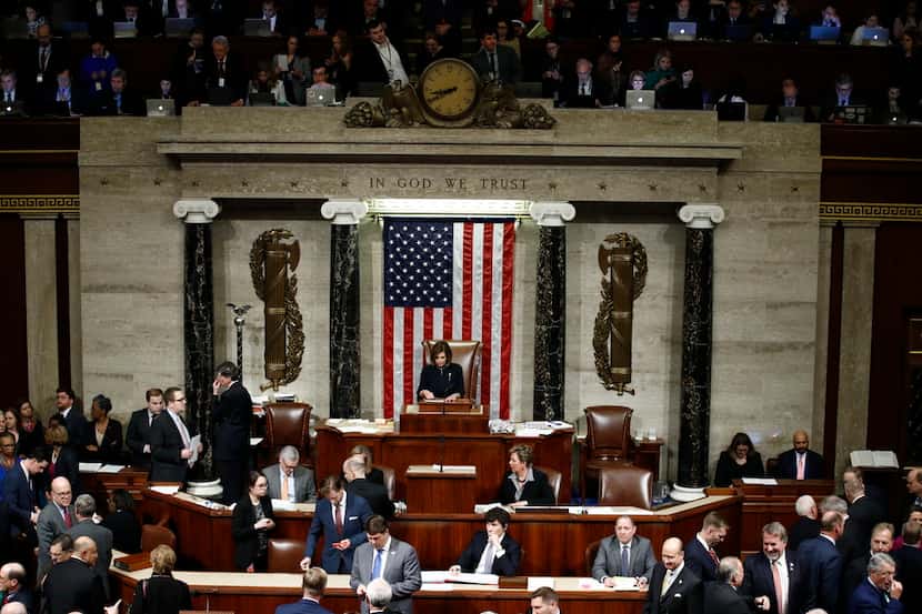 As members vote, House Speaker Nancy Pelosi of Calif., stands on the dais, during a vote on...