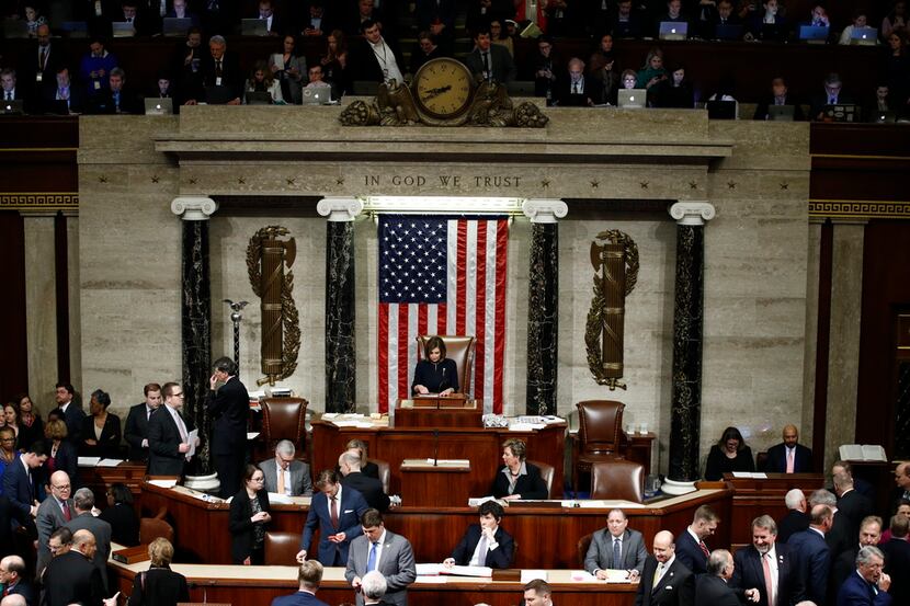 House Speaker Nancy Pelosi stands on the dais during a vote on the Article II of impeachment...