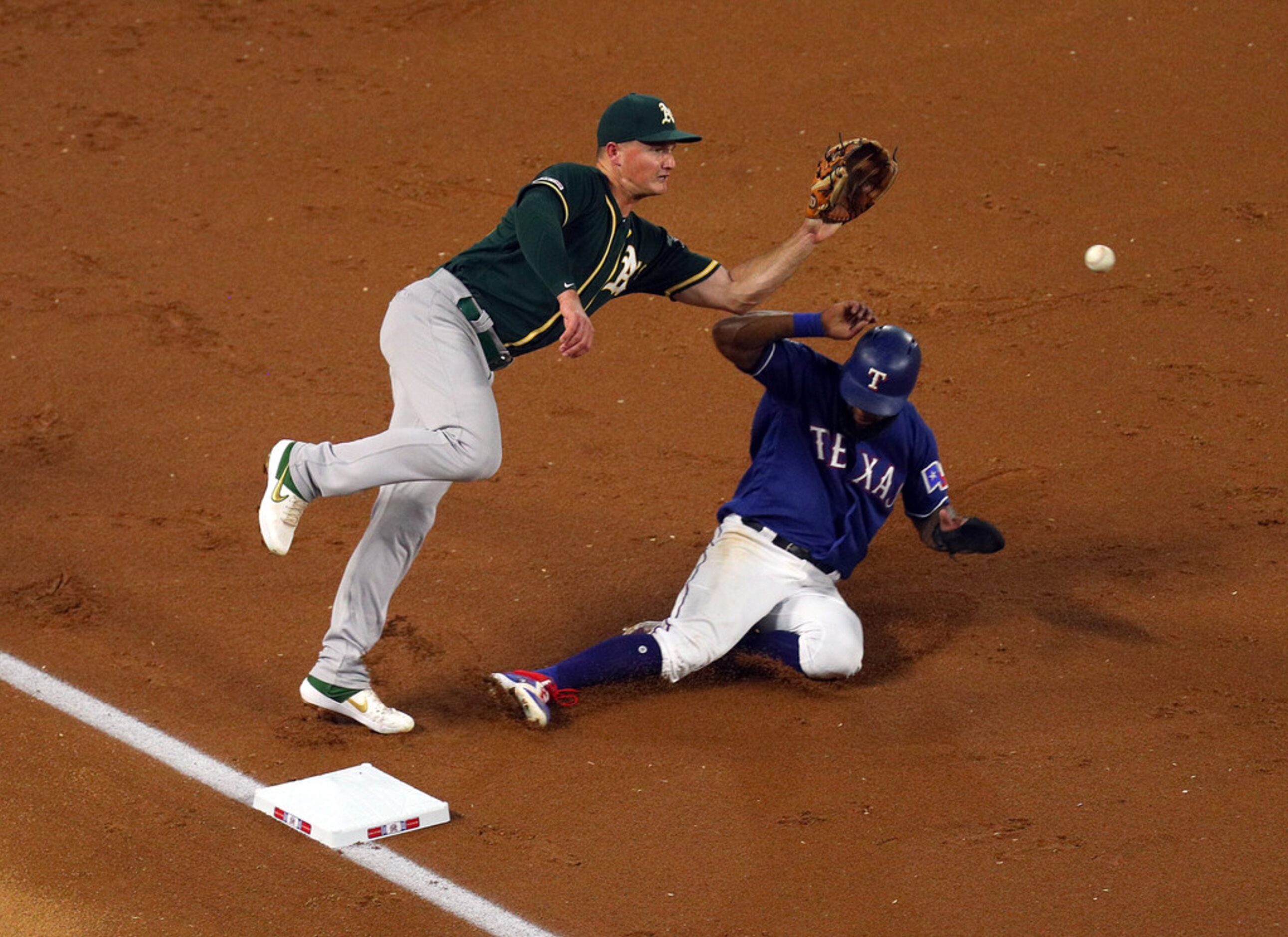 ARLINGTON, TEXAS - SEPTEMBER 14: Matt Chapman #26 of the Oakland Athletics gets the ball...