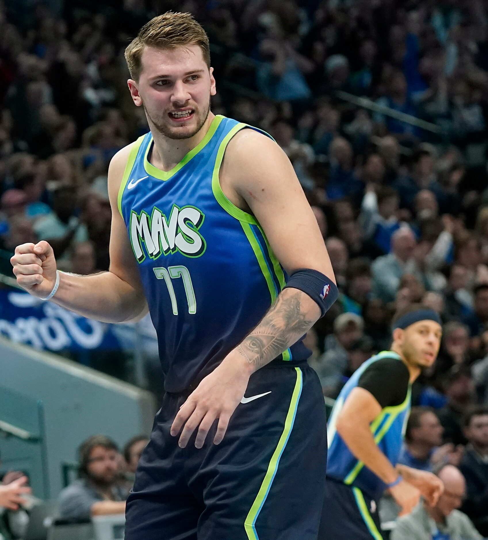 Dallas Mavericks guard Luka Doncic (77) celebrates after scoring during the second half of...